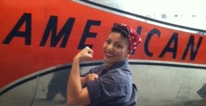 Desi Gibson poses as "Rosie the Riveter" for Women in Space and Aviation Day